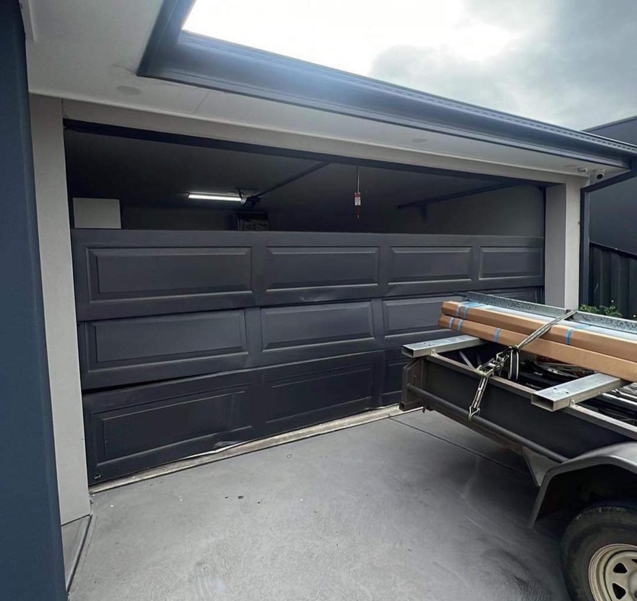 Damaged garage door before repair